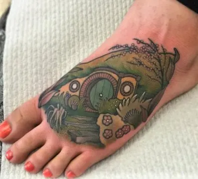 neo-traditional hobbit hole foot tattoo