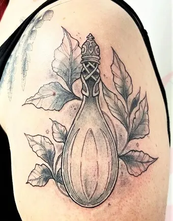Vial of Galadriel tattoo on a woman's upper arm