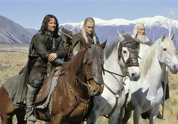 Aragron on Brego the horse, with Legolas and Gandalf on horses