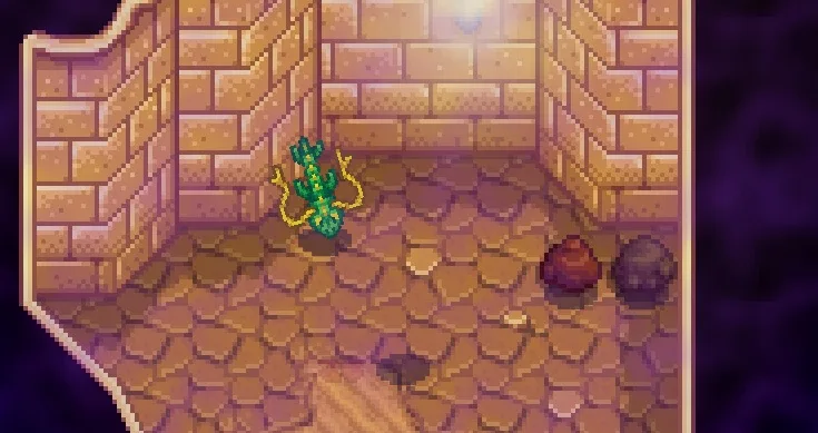 Screenshot of Skull Cavern. A green serpent monster flies through a sandy dungeon room.