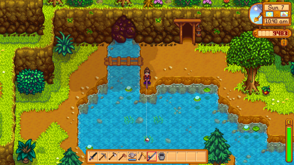 Screenshot of Stardew Valley. The player fishes from the jutting point just below the glittering boulder and the mines at the Mountain Lake.