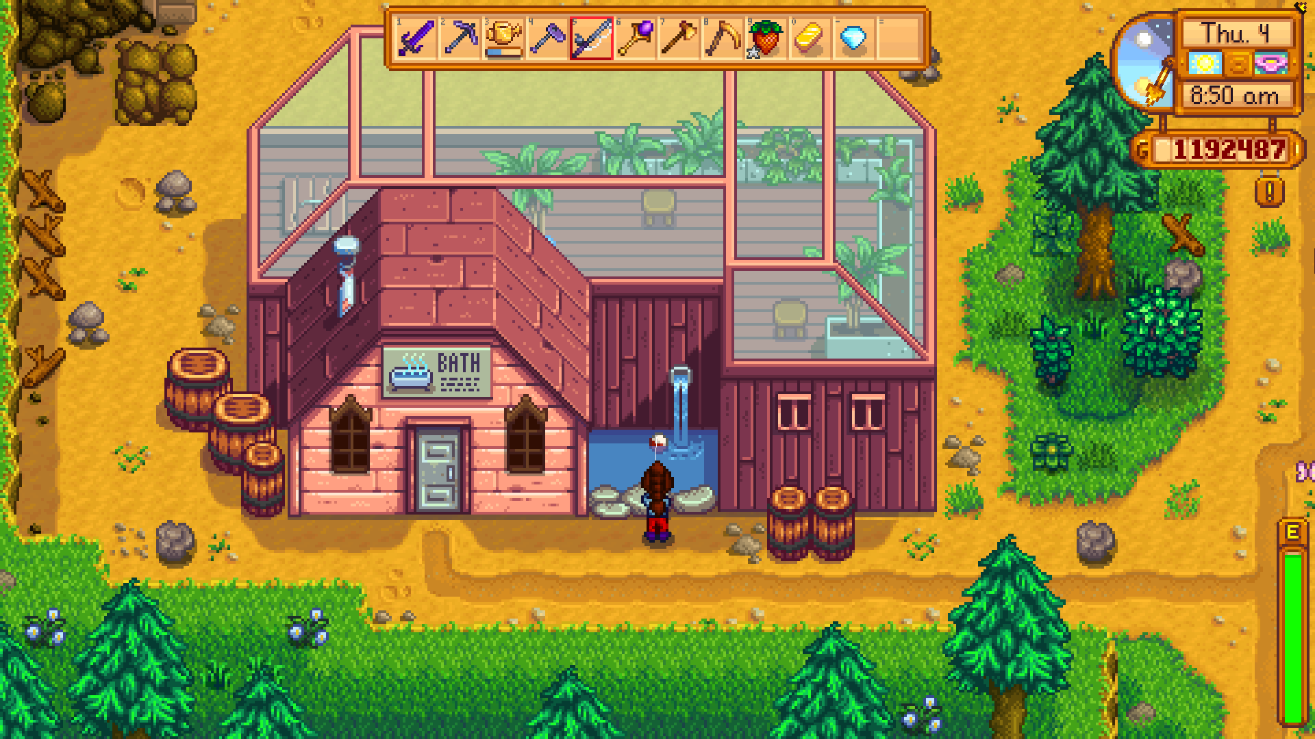 Screenshot of Stardew Valley. The player fishes in the small pond outside the bathhouse.