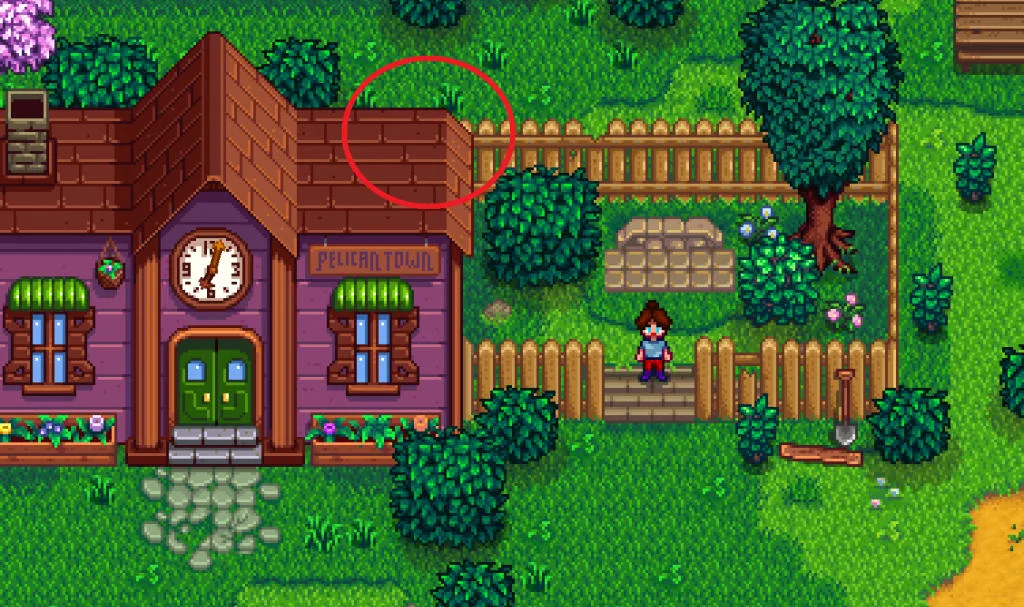 Screenshot of Stardew Valley. The player stands beside the completed community center. There is a red circle drawn around the upper righthand corner of the community center roof.